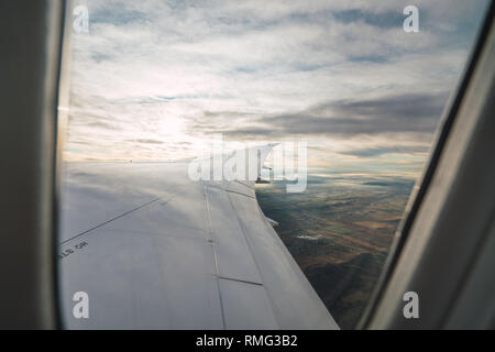 Bearded passenger using device in aircraft Stock Photo