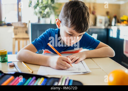 Little boy doing homework in his home Stock Photo