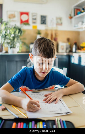 Little boy doing homework in his home Stock Photo