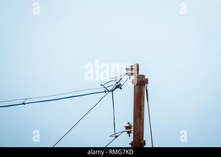Open wires on lamp posts a major hazard due to poor wiring can increase chance of fire. Causes accidents due to electric shock to electrician and bird Stock Photo