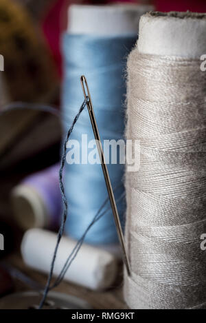 variuous dressmaking tools with, needle and thread, cotton, buttons on old wood Stock Photo