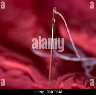 variuous dressmaking tools with, needle and thread, cotton, buttons on old wood Stock Photo
