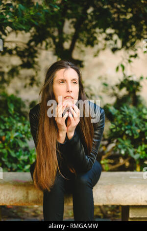 Serious and doubtful young woman with unsure face, feeling uncertain considering making decision, copy free space for text. Stock Photo