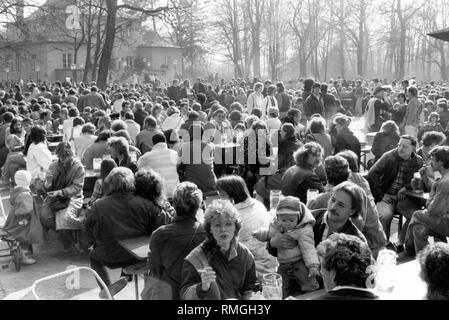 In spring many people are sitting in the beer garden at the Chinese Tower in the Englischer Garten in Munich. Stock Photo