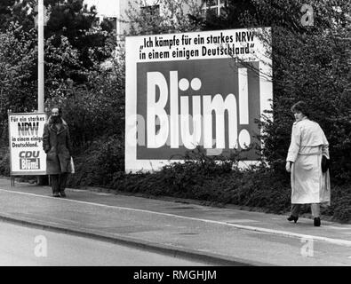 Two election posters of Norbert Bluems, the leading candidate of the CDU for the state elections in North Rhine-Westphalia on 12.5.1985. In the middle, a large poster with the inscription 'I fight for a strong NRW in an own Germany. - Norbert Bluem'. Including 'Bluem!next to it a slightly smaller poster 'For a strong NRW in an own Germany. -CDU, Bluem!'. Here the word 'NRW' is striped in the colors of the German national flag.  In front of the posters are two passers-by. Stock Photo