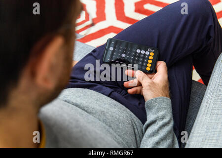 LONDON, UK - SEP 21, 2018: Man using the new Apple iPhone Xs with the immense OLED retina display and a12 bionic chip, looking over the app application using calculator calculations app scientific Stock Photo