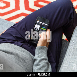LONDON, UK - SEP 21, 2018: Man using the new Apple iPhone Xs with the immense OLED retina display and a12 bionic chip, looking over the app application  Stock Photo