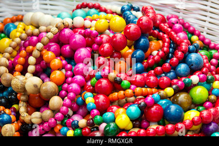 Ethnic wooden multicolored necklaces at market, traditional decorations. Stock Photo