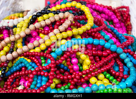 Ethnic wooden multicolored necklaces at market, traditional decorations Stock Photo