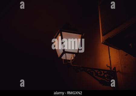 Street lamp lit at night in urban street, technology Stock Photo