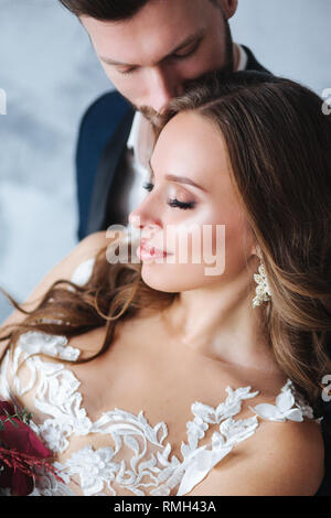 Wedding couple hugging each other indoor.Close-up portrait of weeding couple . Beauty bride with groom. Stock Photo