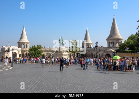 Tourists on the square by Fisherman's Bastion and the statue of Saint Stephen in the Castle District of Budapest Stock Photo