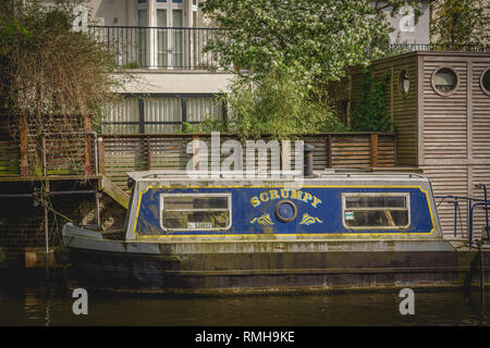 London, UK - May, 2018. A small narrow boat moored along the Regents Canal near Camden Lock in North London. Stock Photo