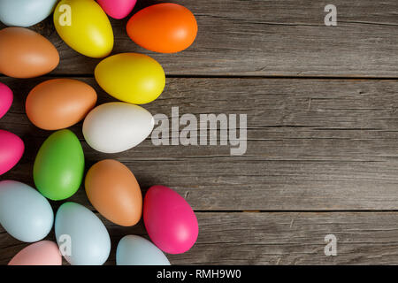 Easter eggs on old wooden board in rustic style top view. Greeting card Stock Photo