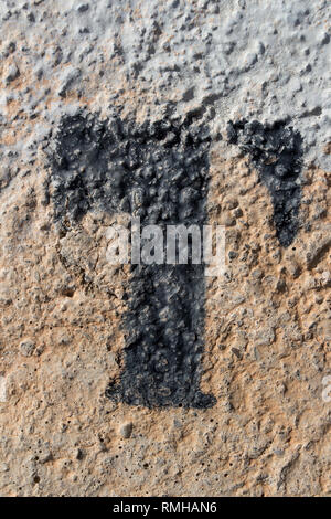 stencil letters in spray paint  on concrete wall, letter t Stock Photo