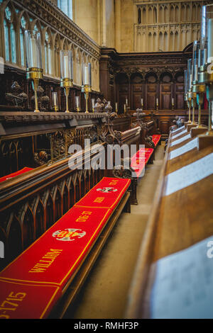 Canterbury, UK - May, 2018. Dark brown wooden choir stalls, most of which are Victorian, in the Quire within the Cathedral. Stock Photo