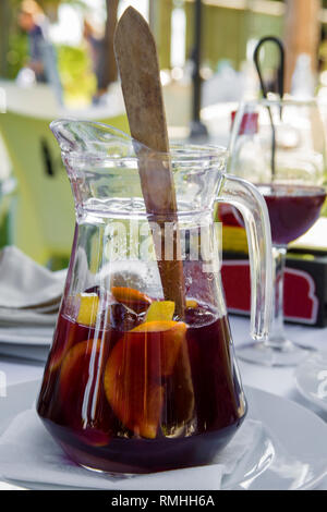 Jug of sangria on a white table. Glass goblets. Concept of relaxation and enjoyment of life Stock Photo
