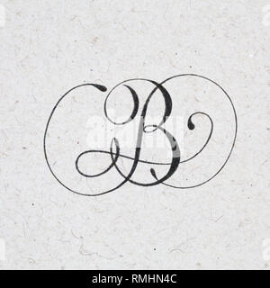 Calligraphic letter B with flourishes - ink bleed on kraft textured paper Stock Photo