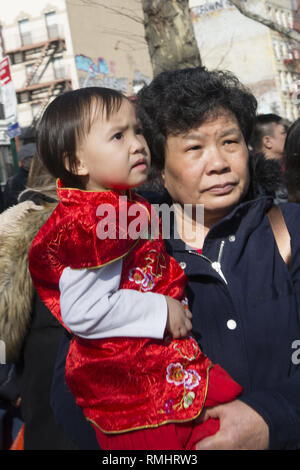 Chinese Grandma and granddaughter welcome in The Year of the Pig at Lunar New Year celebrations in Chinatown, New York City. Stock Photo