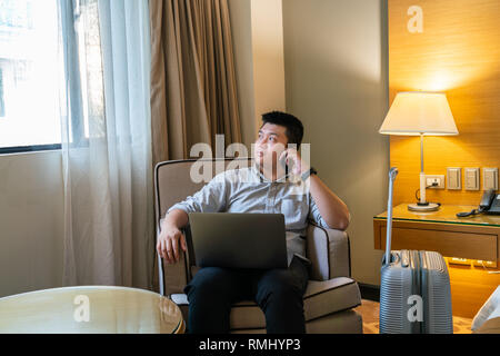 Asian man talking on smartphone Stock Photo