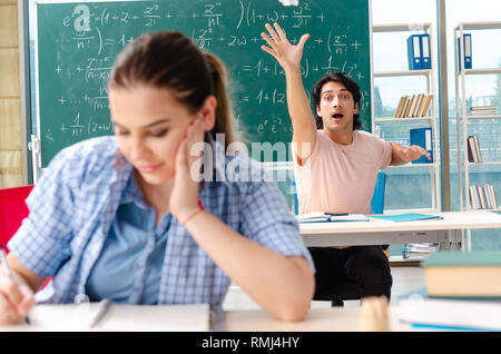 Young students taking the math exam in classroom Stock Photo