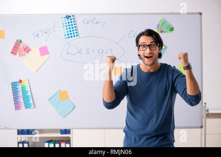Young handsome designer working at the project Stock Photo