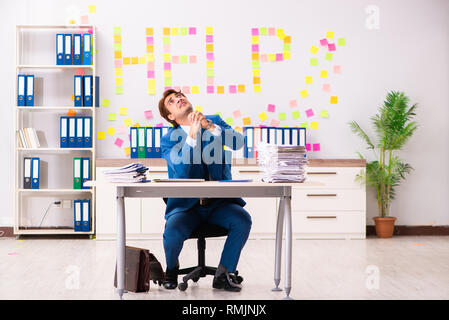 Young employee suffering from excessive work Stock Photo