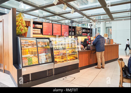 HONG KONG - CIRCA DECEMBER, 2014: Starbucks at Hong Kong International Airport. Starbucks Corporation is an American coffee company and coffeehouse ch Stock Photo