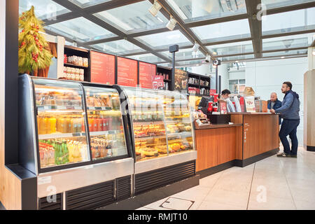 HONG KONG - CIRCA DECEMBER, 2014: Starbucks at Hong Kong International Airport. Starbucks Corporation is an American coffee company and coffeehouse ch Stock Photo