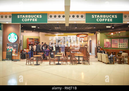 HONG KONG - FEBRUARY 04, 2015: Starbucks at Hong Kong International Airport. Starbucks Corporation is an American coffee company and coffeehouse chain Stock Photo