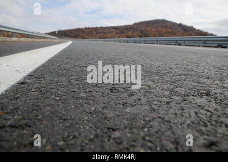 Asphalt road texture with white reflecting line. New road, surface a new asphalt highway Stock Photo