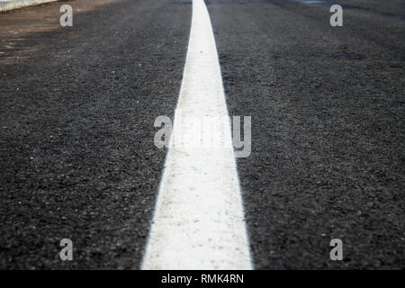 Asphalt road texture with white reflecting line. New road, surface a new asphalt highway Stock Photo