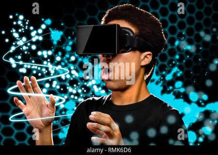 Man wearing a Virtual Reality headset and watching light paintings Stock Photo
