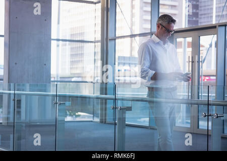 Businessman using his mobile phone in the office Stock Photo
