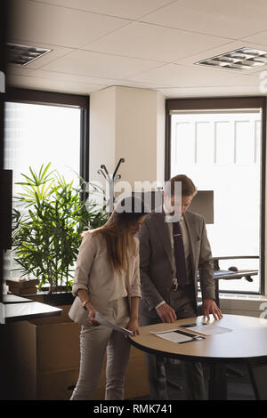 People discussing over documents in the office Stock Photo