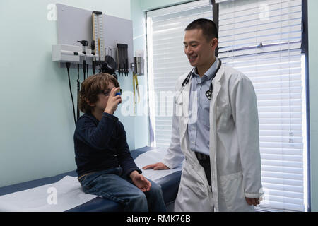 Caucasian boy patient in using asthma inhaler Stock Photo