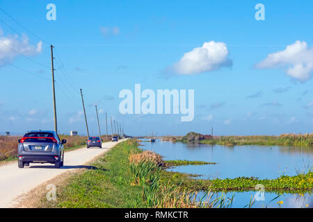 Line of cars slowly drive the canals  looking for  birds  on the Lake Apopka North Shore  Wildlfie Drive near Orlando Florida Stock Photo