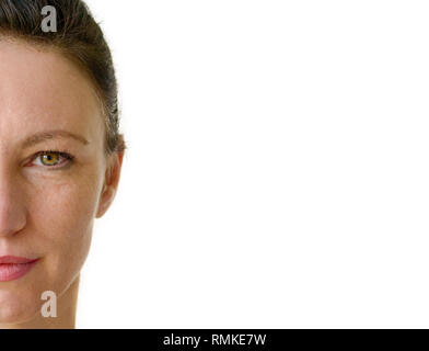 Half face portrait of an attractive brunette woman with green eyes forming a side border over white with copy space Stock Photo