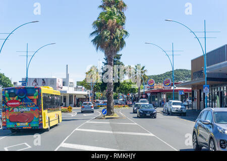 MOUNT MAUNGANUI NEW ZEALAND - FEBRUARY 8 2019: Maunganui Road in main shopping area with passing vehicles and people, Stock Photo