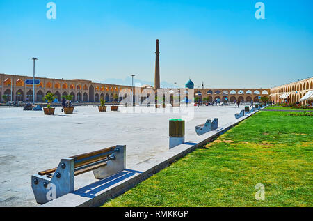 ISFAHAN, IRAN - OCTOBER 21, 2017: The huge Imam Ali (Atiq, Kohneh) Square with line of stores in historic complex around ita and the oldest city minar Stock Photo