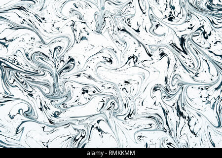 Abstract mixed black and white liquid or acrylic paint. Background concept with high contrast in close-up and full frame Stock Photo
