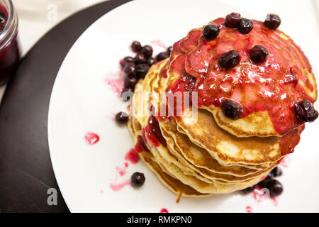 Summer breakfast, homemade classic american pancakes with fresh berry and blueberry butter, white background copy space top view Stock Photo