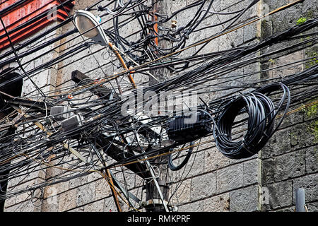 Massive Tangle of cables and wires in the Chinatown area of the city of Manila, Philippines Stock Photo