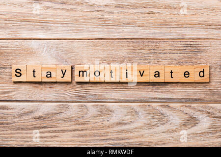 Stay motivated word written on wood block. Stay motivated text on wooden table for your desing, concept. Stock Photo
