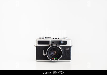 Old compact film camera debranded rangefinder isolated against pure white front view Stock Photo