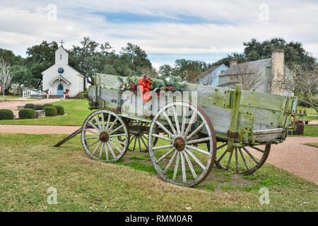 Round Top, Texas, United States of America - December 27, 2016. Historic cart at Henkel Square Market in Round Top, TX, with buildings in the backgrou Stock Photo