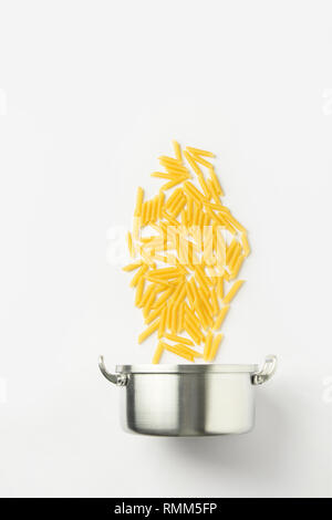 Cooking pot with raw pasta and boiling water on electric stove in ...