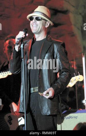 Actor, film producer and singer Bruce Willis is shown performing on stage during a 'live' concert appearance. Stock Photo