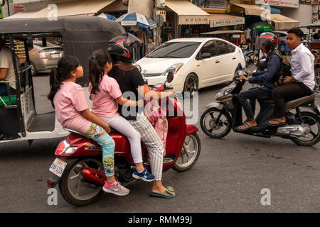 Cambodia, Phnom Penh, Chamkar Mon District, Russian Market, Phsar, Tuol Tom Poung, traffic chaos, at road junction, three people on motorbike Stock Photo