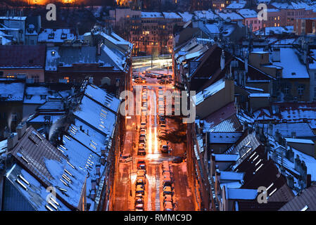 Oldrichova street. Houses with traditional tiled roofs. Late evening. Winter. Snow. View from the Nusle bridge. Stock Photo